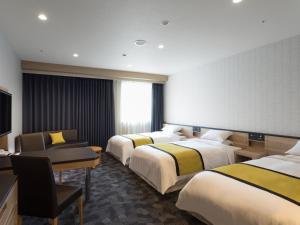 Postel nebo postele na pokoji v ubytování Hotel Hewitt Koshien