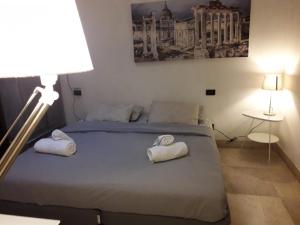 a bedroom with a bed with towels on it at Parioli House near Borghese-LUISS University in Rome