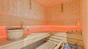 a wooden sauna with a bucket in it at Dom & House - Apartments Waterlane Island in Gdańsk