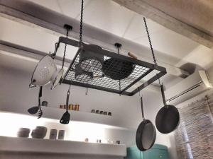 a rack with pots and pans hanging from a ceiling at Villa Arion in Batsi +6 photos