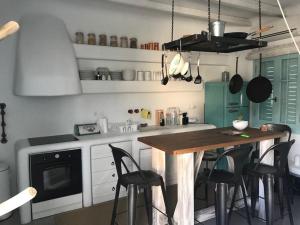 a kitchen with a wooden table and some chairs at Villa Arion in Batsi