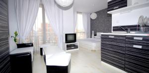 a bathroom with a sink and a tv in it at Hotel Rainbow 3 Resort Club in Sunny Beach