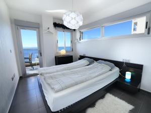 a bedroom with two beds and a view of the ocean at La Manga Beach Club Apartments in La Manga del Mar Menor