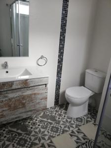 a bathroom with a toilet and a sink at Prado Design Apartment in Gandía +14 photos