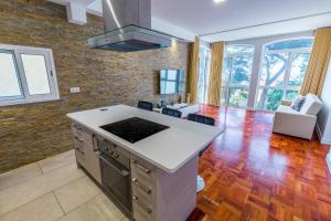 a kitchen with an island in the middle of a room at Sea Breeze II in Caniço