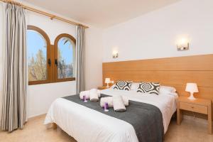 a bedroom with two beds and a window at Sunset Villa Nixe in Alcudia