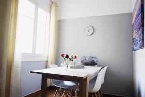 a dining room table with a vase of flowers on it at Luxury 3BDroom View Apartment City Center in Athens