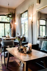 a living room with a wooden table with candles at Sommers "Schöne Aussicht", Adults only in Reichenbach im Vogtland