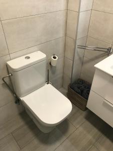 a bathroom with a white toilet and a sink at Apartament L'Alba in Tossa de Mar +16 photos