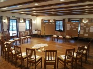 a room with a bunch of chairs and tables at Der Lautenbachhof in Bad Teinach-Zavelstein