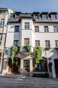 a large white building with windows on a street at Sommers Hotel Altes Posteck in Reichenbach im Vogtland