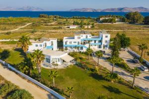 an aerial view of a large white house with palm trees at Anthia Apartments in Marmari
