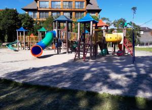 a playground with many different types of playground equipment at 100% Flats in Gramado