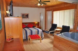 um quarto com uma cama e uma casa de banho com um lavatório em Le Boisé du Lac em Mont-Tremblant