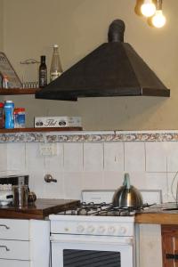 a kitchen with a stove with a pot on it at Quinta El Monte in Tandil