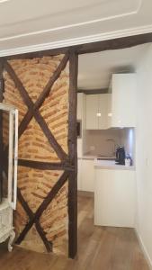 a barn door in a room with a kitchen at Charming Apartment I Historical Center in Lisbon
