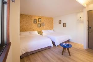 Una cama o camas en una habitación de Light Hostel - Tainan