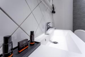 a bathroom with a white sink and a white toilet at Hotel Tiffany in Copenhagen