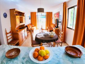 a living room with a bowl of fruit on a table at Bon Aire Apartamentos in Paguera