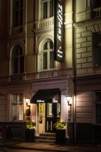 a building with a sign on the side of it at Hotel Tiffany in Copenhagen