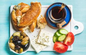 a plate of food with bread and a cup of coffee at Dida moj in Senj
