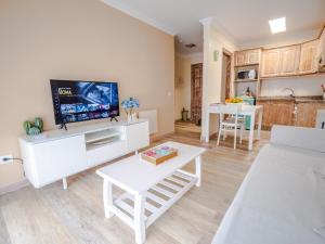 a living room with a tv and a table at ElHierroBed&Chic in Valverde