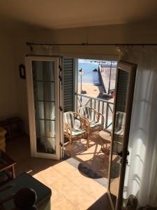 an open door to a balcony with a view of the beach at Apartamento El Muelle in Arrieta