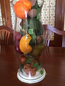 a vase filled with fruits and vegetables on a table at Apartamento El Muelle in Arrieta +25 photos
