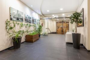 a lobby with potted plants on the walls at Slow Suites Gran Vía in Madrid