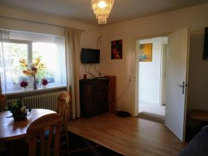 a living room with a dining room table and a window at Familiehuis Dolve 2 in Hartheim