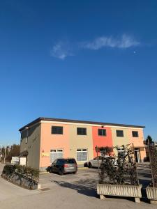 a building with cars parked in a parking lot at Apartman Decorus in Maribor