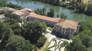 an aerial view of a building next to a river at Centre Louis Ormières in Montauban