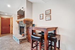 a living room with a table and a fireplace at Runaway to the Ridge in Ronald