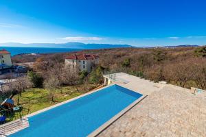 an overhead view of a swimming pool in a house at Luxury apartments Kostrena with pool in Kostrena