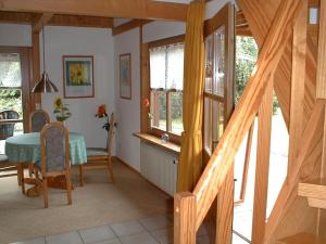 a dining room with a table and chairs and a staircase at Fewo to Hus in Bad Bederkesa