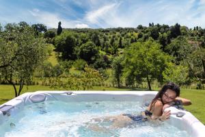 a woman sitting in a pool of water with a dog at Poggio Baronti B&B in Bagno a Ripoli