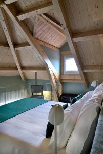 a large bed in a room with a wooden ceiling at Mayor's Apartments in Porto