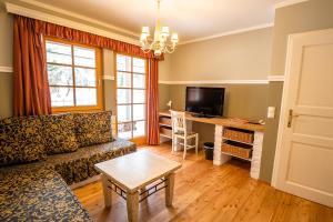 a living room with a couch and a table at Kinderhotel Appelhof in Mürzsteg