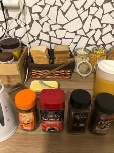 a table with jars of spices and a basket of food at Pil Pil Hostel Bilbao in Bilbao