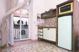 a room with a refrigerator and a window at Casa Antonia in Naples