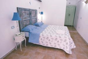 a bedroom with a bed and a table with a lamp at Casa Antonia in Naples