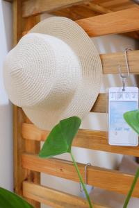 a hat on a shelf with a clock on it at Just Fine Krabi in Krabi town
