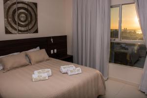 a bedroom with a bed with two pillows on it at SERPYL Plaza Hotel in Encarnación