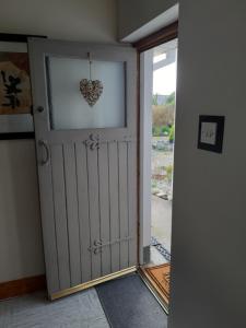 an open door with a heart hanging on it at An Crann Glas in Galway
