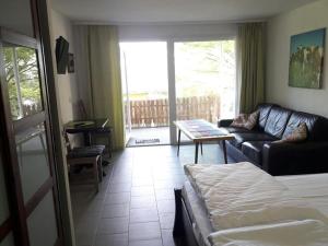 a living room with a couch and a table at Bungalows Zur Alten Fähre in Werder