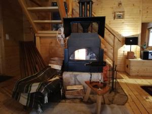a room with a stove in a log cabin at Vikendice Biocinovici in Kolašin