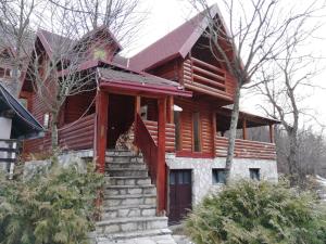 a log home with stairs in front of it at Vikendice Biocinovici in Kolašin