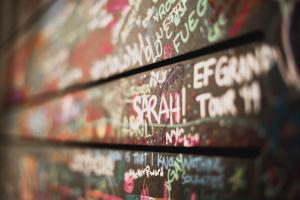 a wall covered in graffiti with writing on it at Room Ventura in Madrid