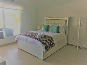 a bedroom with a bed with two shoes on it at Providence Breeze in San Andrés