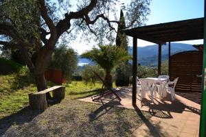 a patio with a table and chairs under a pavilion at Il Poggio Marcuccio in Lacona